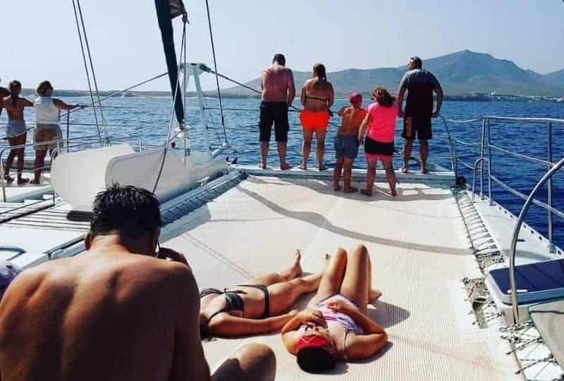 Tourists sunbathing on the deck